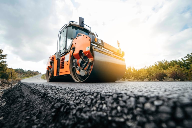 Vibratory asphalt roller compactor compacting new asphalt pavement in Cedar Park, TX