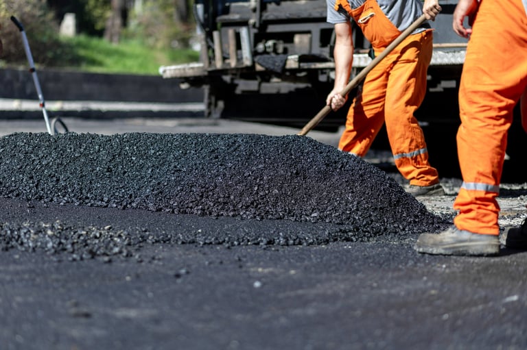 Paving crew installing fresh asphalt driveway in Cedar Park, TX