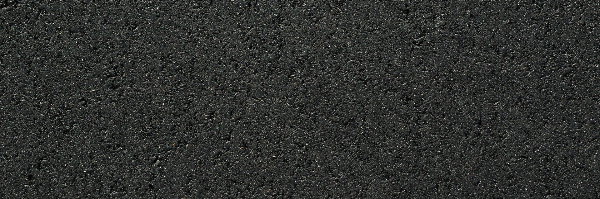 Close up texture of smooth new black asphalt pavement surface